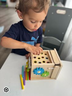 a young child playing with wooden toys on a table