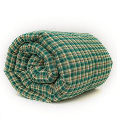 a green and white plaid blanket folded on top of each other with the bottom rolled up