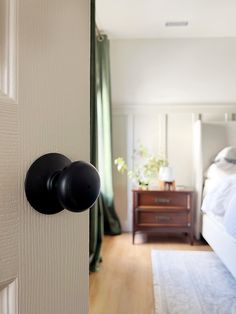 an open door with two black knobs on it