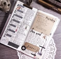 an open planner book sitting on top of a wooden table