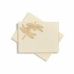 two cards with dragonflys on them, one in gold and the other in white