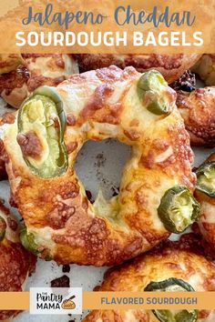 jalapeno cheddan sourdough bagels are piled on top of each other