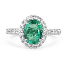 an oval cut green tourmaline surrounded by white diamonds in a halo style setting