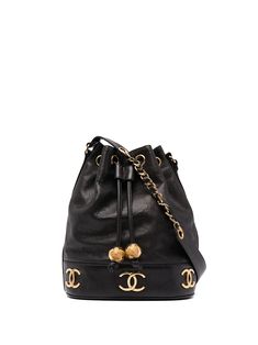 Black caviar leather 1992 Triple CC bucket bag from Chanel Pre-Owned featuring signature interlocking CC logo, gold-tone hardware, drawstring fastening, foldover top, leather and chain-link shoulder strap and circa 1992. Please be mindful that this piece has led a previous life, and may tell its story through minor imperfection. Purchasing this item continues its narrative, so you can be confident that you’re making a POSITIVELY CONSCIOUS choice for the planet.. | Chanel Pre Owned 1992 Triple CC Chanel Bucket Bag, Drawstring Shoulder Bag, Shopping Chanel, Black Caviar, Cc Logo, Gucci Bags, Online Bags, Designer Bags, Luxury Handbags