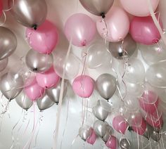 a bunch of balloons that are hanging from the ceiling