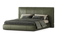 a large bed with green leather headboard and pillows on top of it, in front of a white background