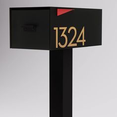 a black mailbox with the number 1234 on it's front and side