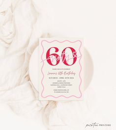 an 80th birthday party card on top of a white plate with pink and red lettering