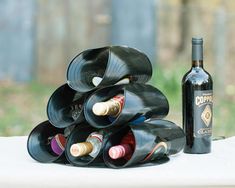 a stack of wine bottles sitting on top of a table