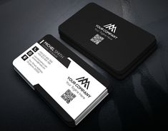 two black and white business cards sitting on top of a table