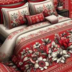 a red and white bed covered in lots of floral designs on it's comforter