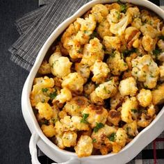 a casserole dish filled with stuffing on top of a table