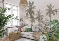 a living room with palm trees on the wall