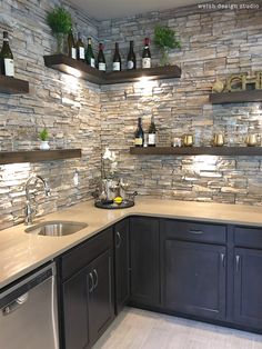 a kitchen with stone walls and stainless steel appliances