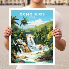 a man holding up a poster in front of a building with a waterfall and palm trees