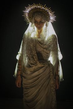 an image of a woman dressed up like the virgin of guadalupe in white and gold