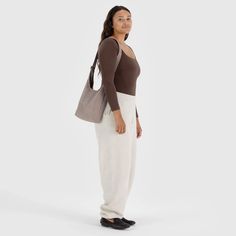 A slouchy, softly structured nylon bag with an adjustable strap. Interior zip pocket with a magnetic closure. Heavyweight nylon (59% recycled)9.5"H × 7"W × 4.25"D 39" adjustable strapMachine washable Casual Nylon Hobo Bag For On-the-go, Casual Hobo Bag With Zipper Pocket, Casual Tote Baguette Bag With Zipper Pocket, Casual Everyday Baguette Tote Bag, Casual Baguette Bag With Zipper Pocket, Casual Hobo Bag With Double Handle For On-the-go, Casual Everyday Baguette Bag With Zipper Pocket, Casual Softback Hobo Bag, Casual Nylon Crossbody Hobo Bag