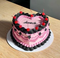 a heart shaped cake with cherries on top