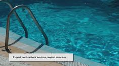 an empty swimming pool with steps leading up to the edge and clear blue water behind it