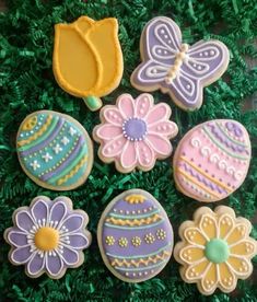 decorated cookies in the shape of easter eggs and flowers