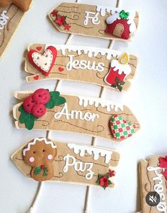 several wooden signs with christmas decorations on them sitting on a white counter top next to cookie cutters