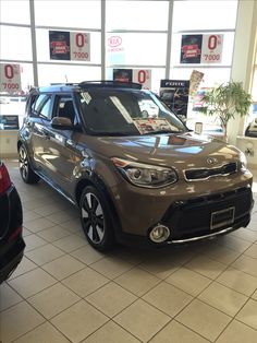 a brown and black car in a showroom