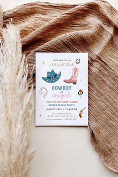 the cowboy baby shower is next to a brown blanket and a white card that reads, cowboy on cowgirl