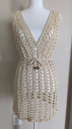 a white crocheted dress on a mannequin