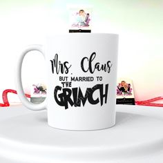 a white coffee mug with the words mrs claus but married to the grinch on it