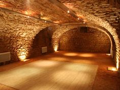 an empty room with stone walls and wooden floors