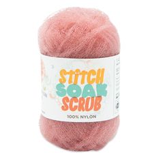 a pink yarn ball with the words stitch soak scrub on it's side