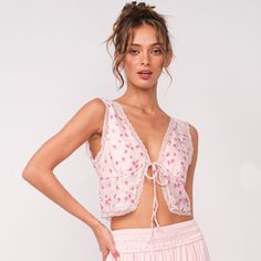 Sleeveless front tied crop top with floral print 100% Polyester Size and Fit: Model height 5’10” wearing size Small Tied Crop Top, Pink Floral Top, Tie Crop Top, Floral Top, Model Height, Pink Floral, Floral Tops, Floral Print, Crop Top