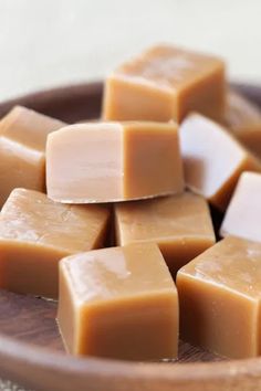 a wooden bowl filled with lots of brown and white squares