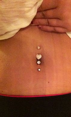 a woman's stomach with three diamonds on it