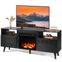 a flat screen tv sitting on top of a wooden entertainment center next to a fire place