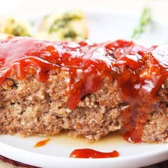 the meatloaf is covered with ketchup and ready to be eaten on the plate