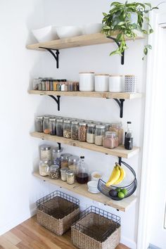 the shelves are filled with spices and other items in baskets on them, along with fruit