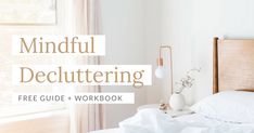 a white bed sitting next to a window with the words mindful decluttering