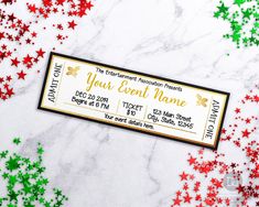 a ticket with red, green and gold stars on it sitting on a marble surface