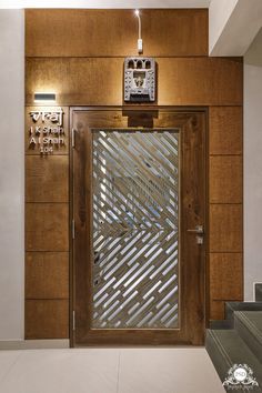 the front door to an office building with a clock on it's wall and stairs