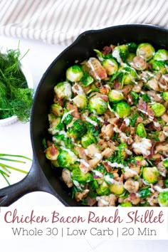 a skillet filled with chicken, bacon and brussel sprouts on top of a table