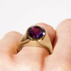 Take your style to a higher level with the magnificent Aphrodite statement ring featuring an oval amethyst made with Fairmined 18k yellow gold by Chroma. • Fairmined 14k yellow gold • 4.90ct Oval Amethyst • Band Width: 2mm - 6mm • In stock in size 6. This ring is able to be resized, please allow 4 weeks. Designed and crafted by us in NYC using recycled gold, conflict-free diamonds and responsibly sourced gemstones. The Fairmined program certifies gold created by small scale mining organizations, Oval Amethyst Ring In Yellow Gold With Polished Finish, Oval Yellow Gold Amethyst Ring With Polished Finish, Timeless Yellow Gold Amethyst Ring With Oval Shape, Timeless Gold Oval Amethyst Ring, Elegant Purple Amethyst Signet Ring, Timeless Oval Gold Amethyst Ring, Timeless Oval Amethyst Ring As Gift, Timeless Oval Amethyst Ring For Gift, Elegant Amethyst Gemstone Signet Ring