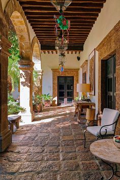 an outdoor area with chairs, tables and lamps