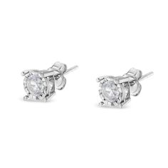 Celebrate any occasion with these classic shimmering diamond stud earrings. Fashioned in .925 sterling silver, each earring showcases a sparkling Ã‚Â¼ carat round, brilliant cut, miracle-set diamond solitaire. The unique miracle-plate setting centers each genuine diamond in a mirror-finish, high-polish frame, giving the illusion of a much larger stone. Dazzling with a bright polished shine, these post earrings secure comfortably with friction posts and butterfly backs. This authentic design is c Timeless Silver Diamond Earrings As Gift, Timeless Silver Diamond Earrings For Gift, Channel Set Cubic Zirconia Earrings Fine Jewelry, White Gold Cubic Zirconia Channel Set Earrings, Diamond White Diamond Earrings With Channel Set, Diamond White Earrings Channel Set Fine Jewelry, Diamond White Channel Set Earrings, Sterling Silver Diamond White Earrings With Round Stone, Silver Diamond Earrings For Anniversary