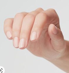 a woman's hand holding onto the tip of her thumb and pointing at it