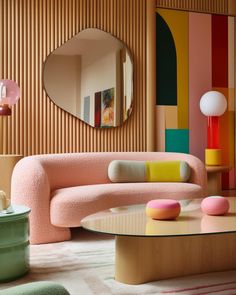 a living room filled with furniture and a round mirror