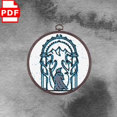 a cross stitch ornament hanging on a wall