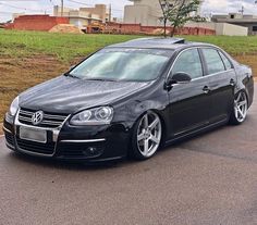 a black car is parked on the street