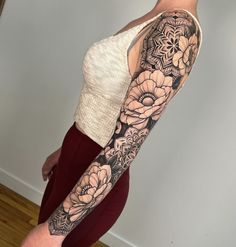 a woman's arm with flowers on it