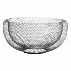 a glass bowl that is sitting on top of a white surface with mesh covering it